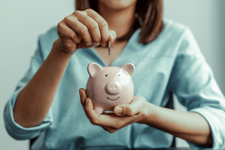 A woman Saves Money in a Piggy Bank Pig